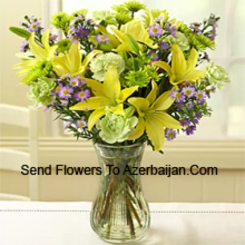 Lirios amarillos y otras flores variadas dispuestas hermosamente en un jarrón de vidrio