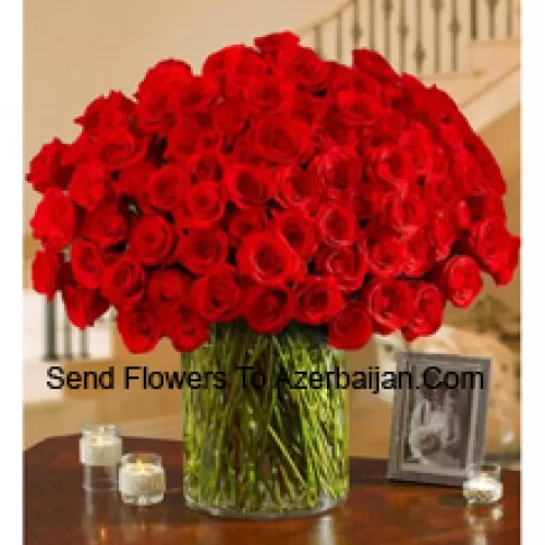 101 Red Roses With Some Ferns In A Big Glass Vase