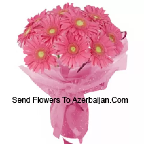 Un magnifique bouquet de 11 gerberas roses avec des garnitures saisonnières